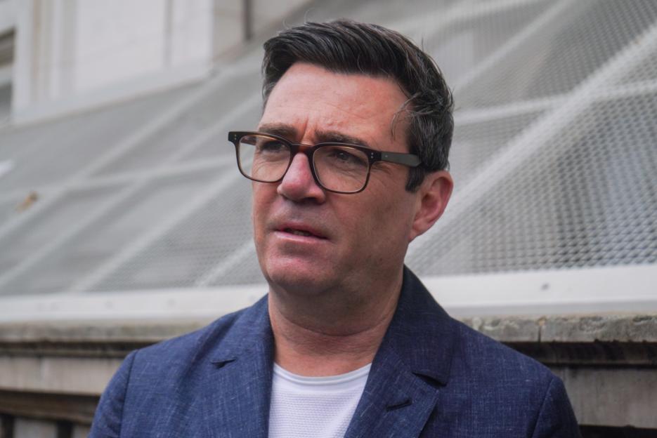 Andy Burnham, Labour Mayor of Greater Manchester, wearing a blue jacket and glasses, outside Downing Street.