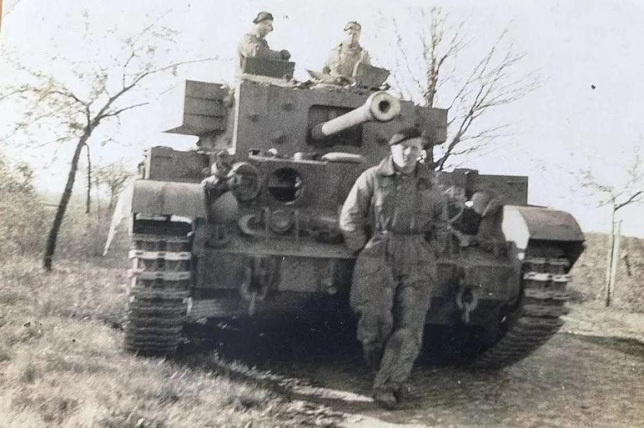 Richard Aldred stands in front of his tank in No Man's Land after the Normandy landings.