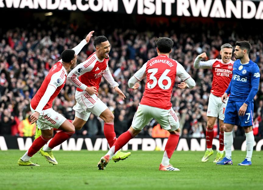 Arsenal players celebrate a goal against Chelsea.