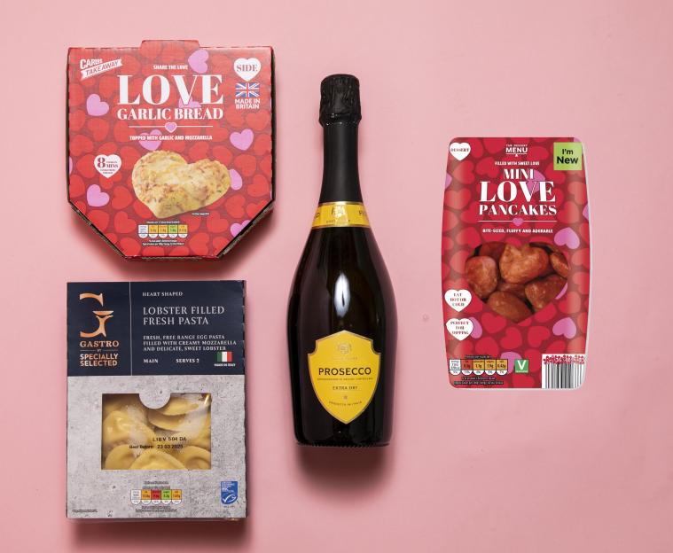 Aldi's Valentine's Day meal deal, including heart-shaped garlic bread, lobster pasta, mini pancakes, and a bottle of Prosecco.