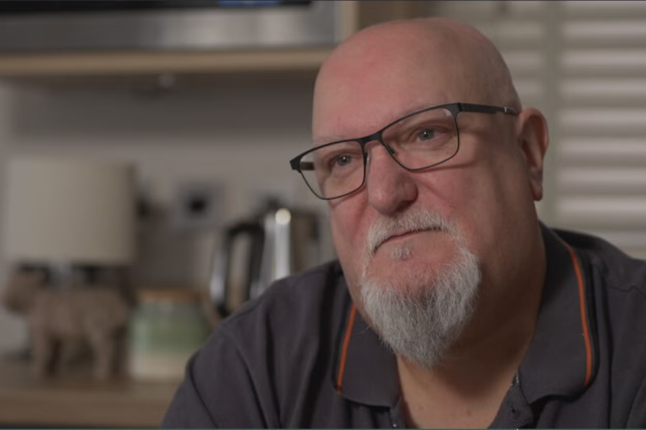 A man with glasses and a goatee, identified as Robert Mifflin, speaks during an interview.