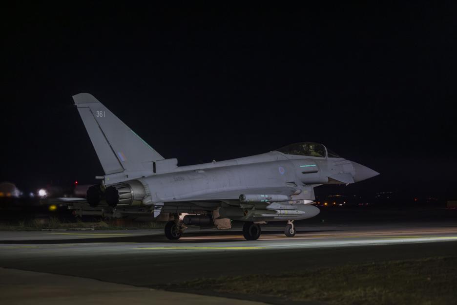 An RAF Typhoon jet taxiing at night on a runway at Akrotiri, Cyprus.