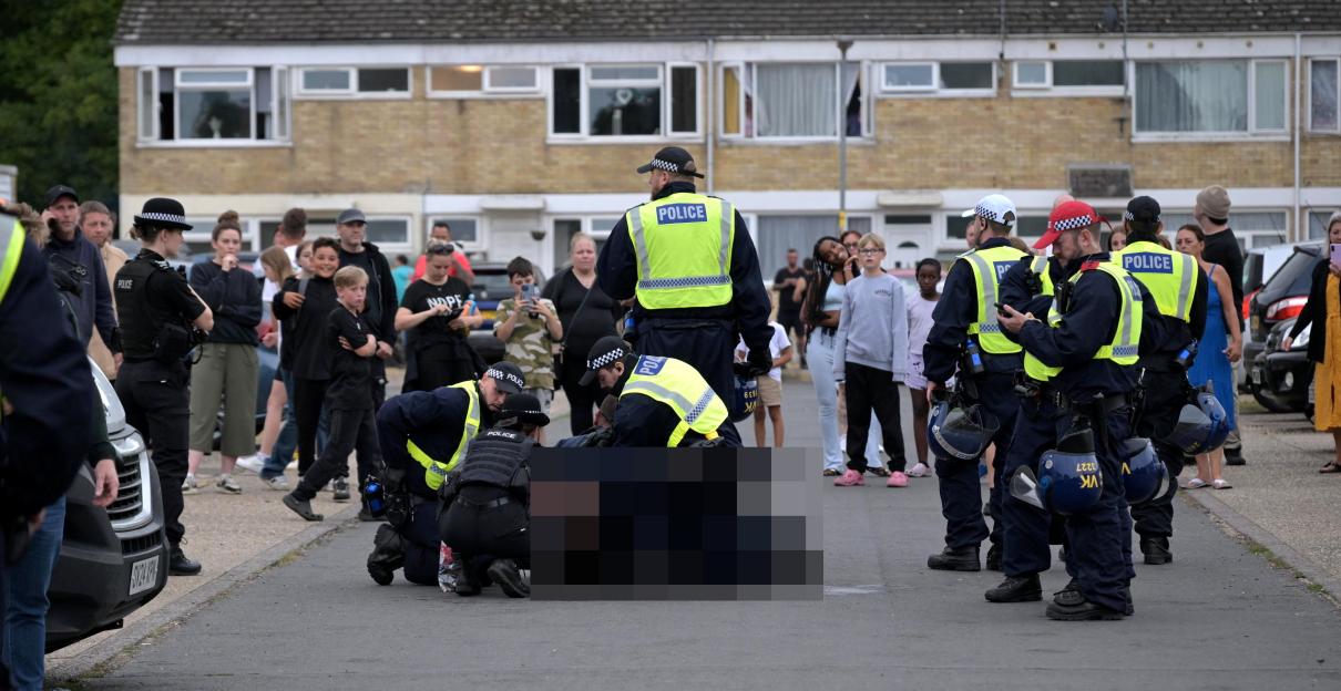 Police making arrests during protests over asylum seekers.