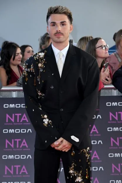Joe Baggs in an embroidered black suit attends the National Television Awards 2026.