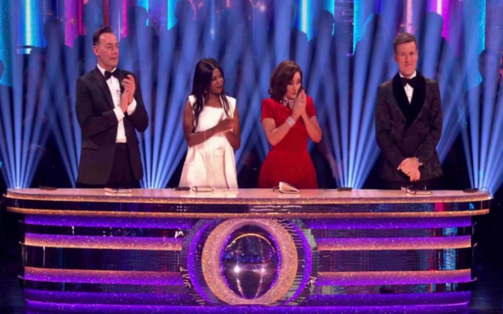 Shirley Ballas and three other judges behind a glittery desk.