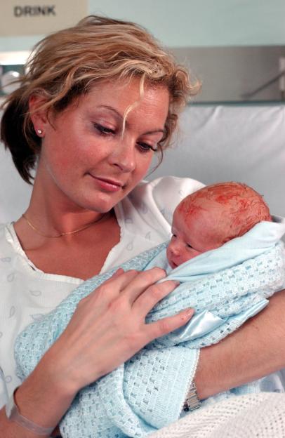 Tracy Shaw as Maxine holding her newborn baby in Coronation Street.