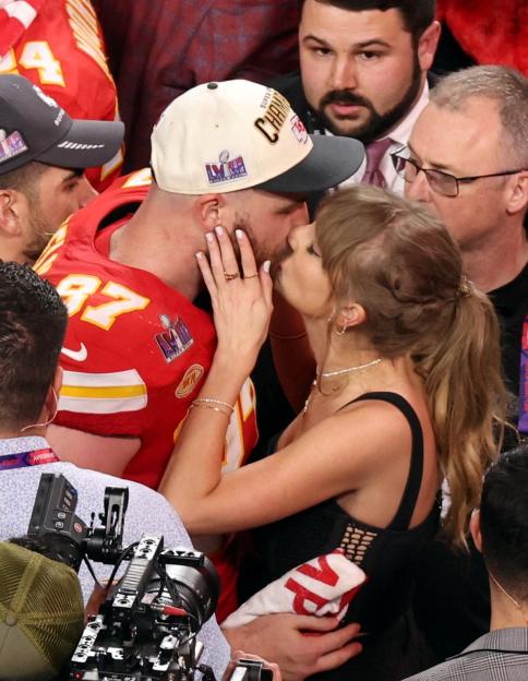 Kansas City Chiefs player Travis Kelce kisses Taylor Swift after Super Bowl LVIII.