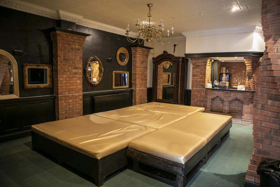 Interior of the playrooms at The Mirage, featuring gold padded surfaces and brick pillars.