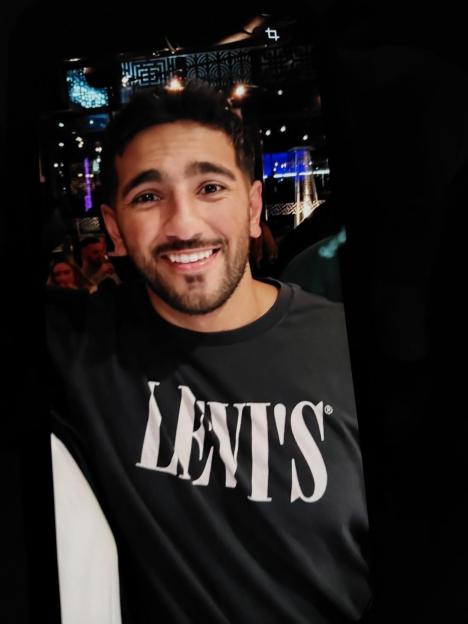 Pc Rehaan Akhtar smiling while wearing a black Levi's t-shirt.