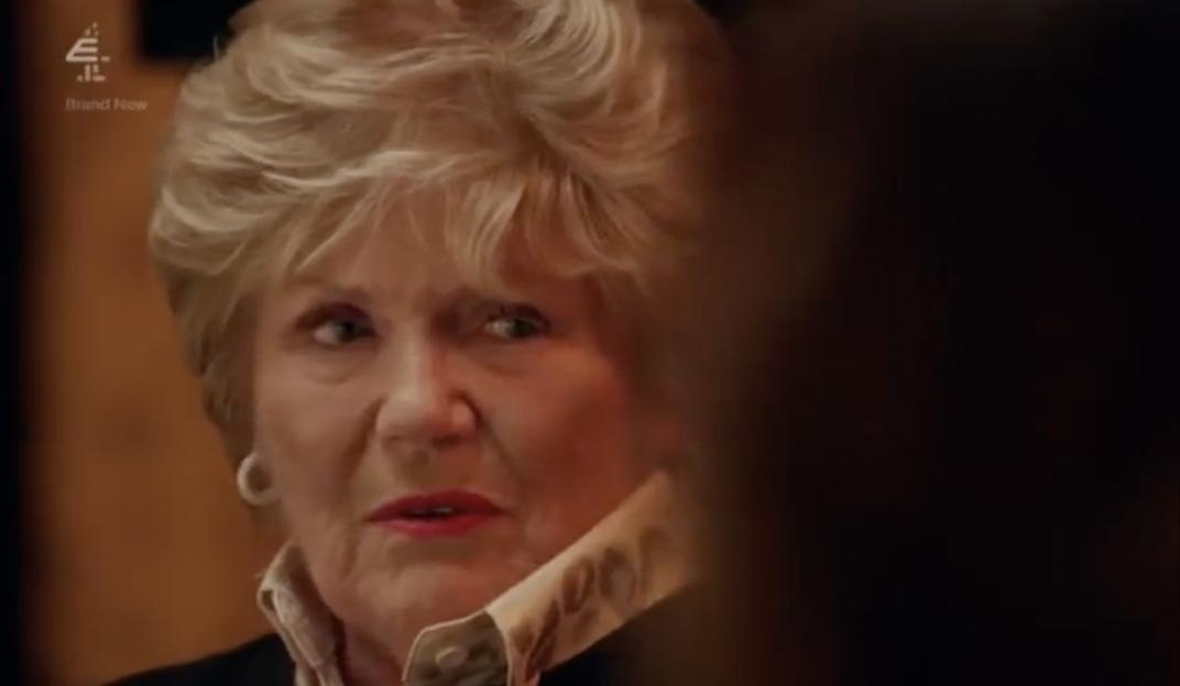 A close-up of a blonde woman, looking surprised.