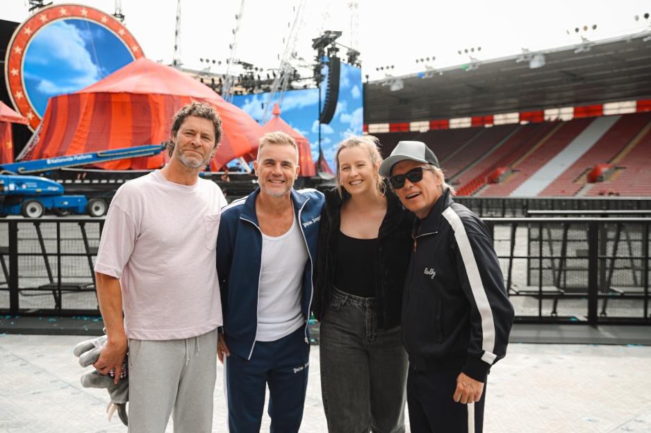 Ellie Henman and members of Take That pose for a photo.