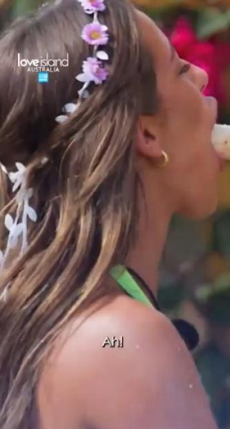 A woman from Love Island Australia eating a banana.
