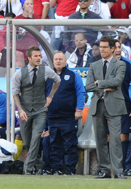 David Beckham and Fabio Capello at a soccer match.