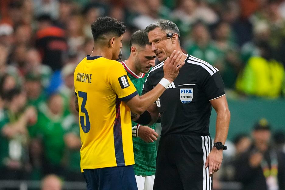 Referee Slavko Vincic speaks to Ecuador's Piero Hincapie.