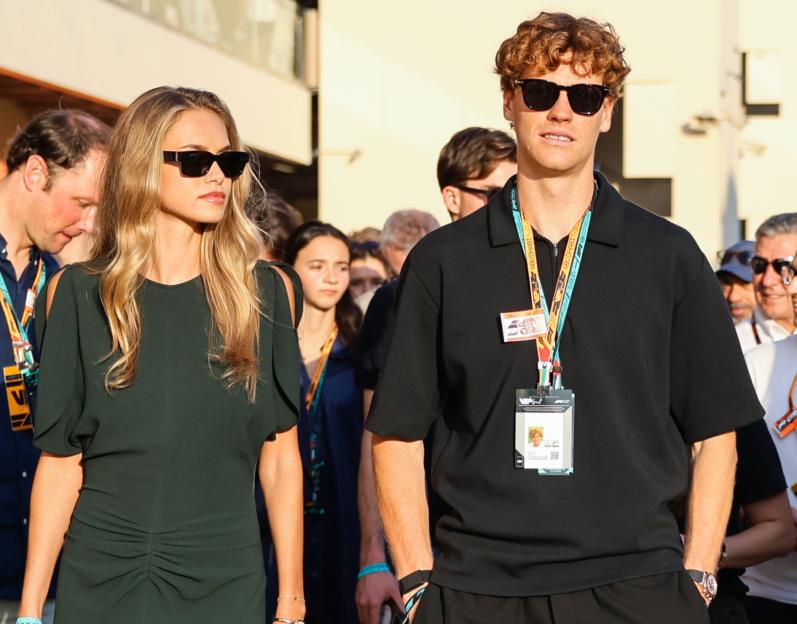 Jannik Sinner and his girlfriend Laila Hasanovic walking in the paddock ahead of the Formula 1 Abu Dhabi Grand Prix.