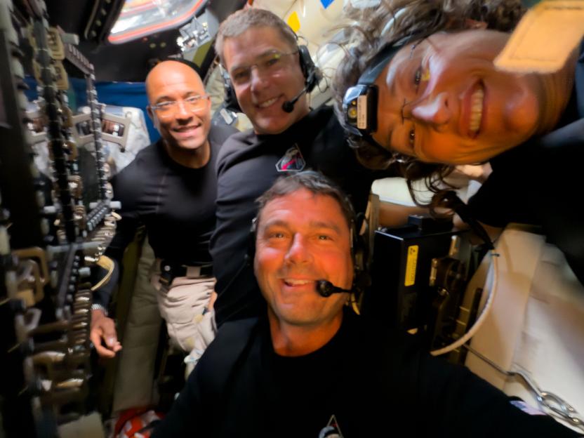 Artemis II crew members Victor Glover, Jeremy Hansen, Reid Wiseman, and Christina Koch pose for a selfie during their lunar observation period.