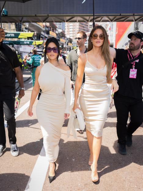 Kim and Khloe Kardashian walk at the F1 Grand Prix of Monaco.