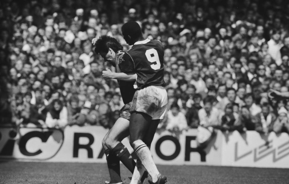 Football players jostling for the ball during West Ham v Chelsea match.