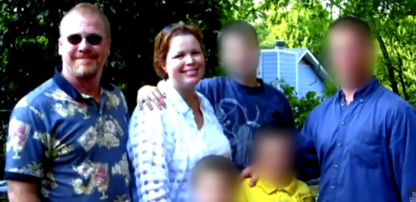 A man and a woman smile at the camera, with four other people whose faces are blurred.