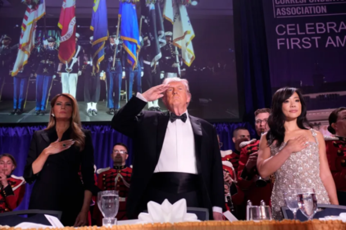 Donald Trump salutes while Melania Trump and Jeanine Pirro place hands over their hearts at a formal event.