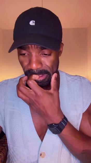 Ore Oduba in tears with his hand to his mouth.