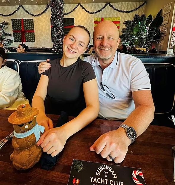 Lucy Harrison and her father Kris smiling together at a restaurant.