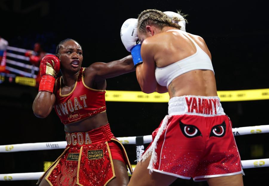 Claressa Shields punching Kaye Scott during a boxing match.