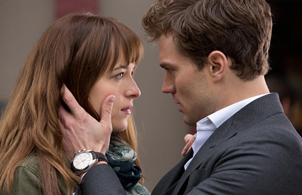 Dakota Johnson as Anastasia "Ana" Steele and Jamie Dornan as Christian Grey in a close embrace.