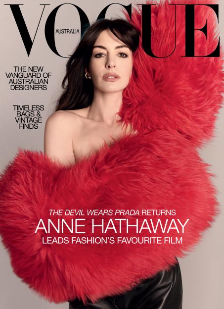 Anne Hathaway on the cover of Vogue Australia, wearing a red faux fur wrap and black skirt.