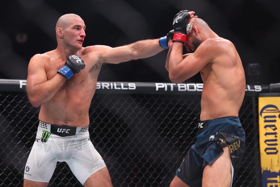 Sean Strickland punching Khamzat Chimaev during a UFC middleweight championship fight.