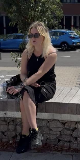 Hannah Metcalfe sitting on a stone and wood bench.