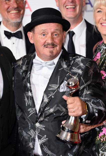 Brendan O'Carroll poses with the Comedy award during the NTAs 2024.