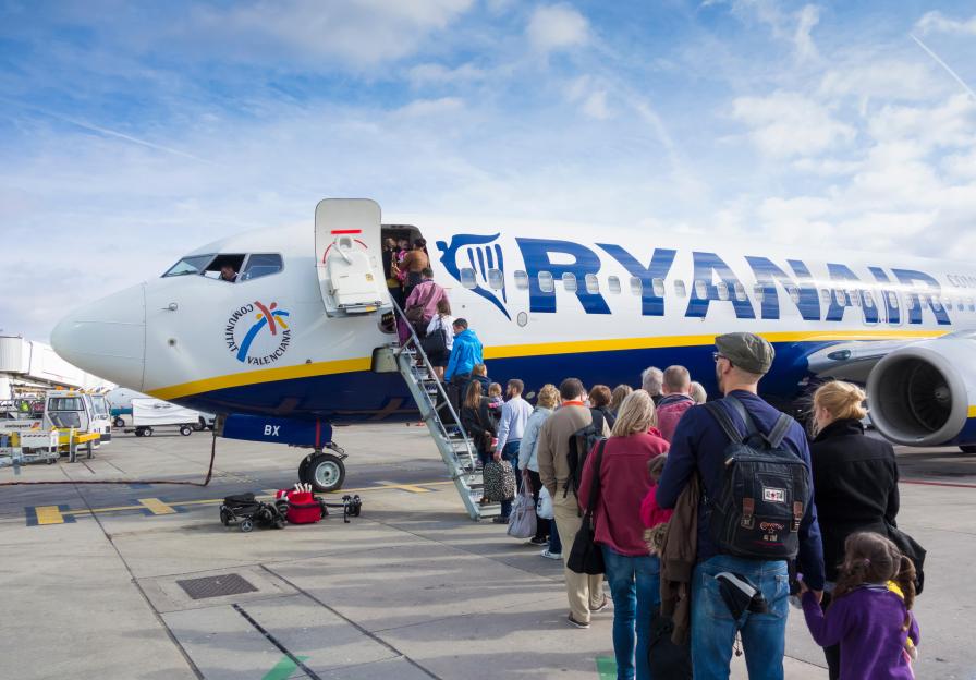 Passengers boarding a Ryanair plane at Manchester Airport.
