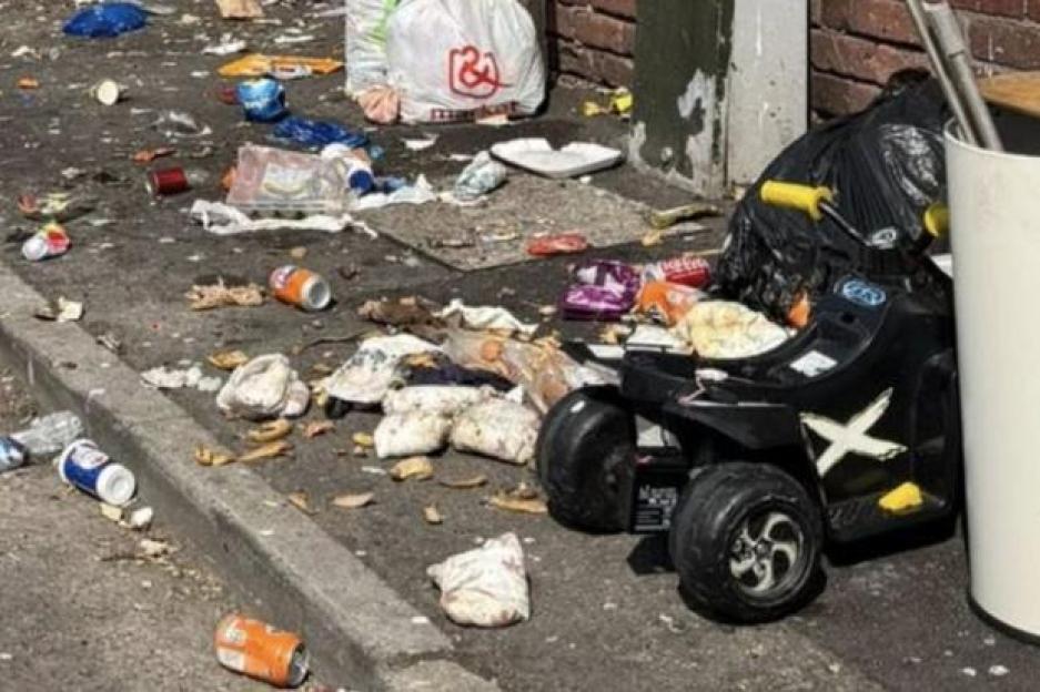 Fly-tipping on Newport's Pottery Road, with garbage and discarded items littering the street and sidewalk.