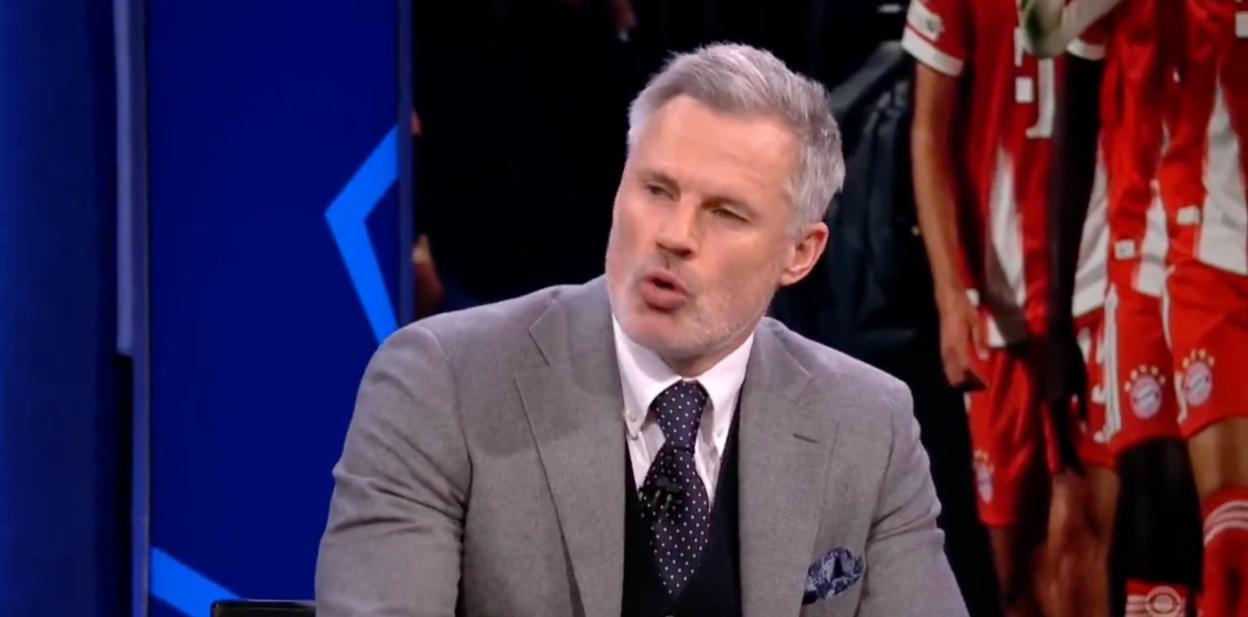 Man in a suit speaking during a broadcast.