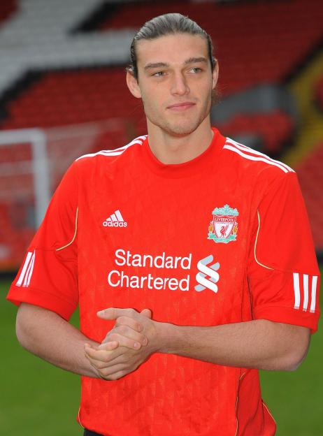 Carroll, Liverpool's new signing, poses for photographers at Anfield stadium in Liverpool.