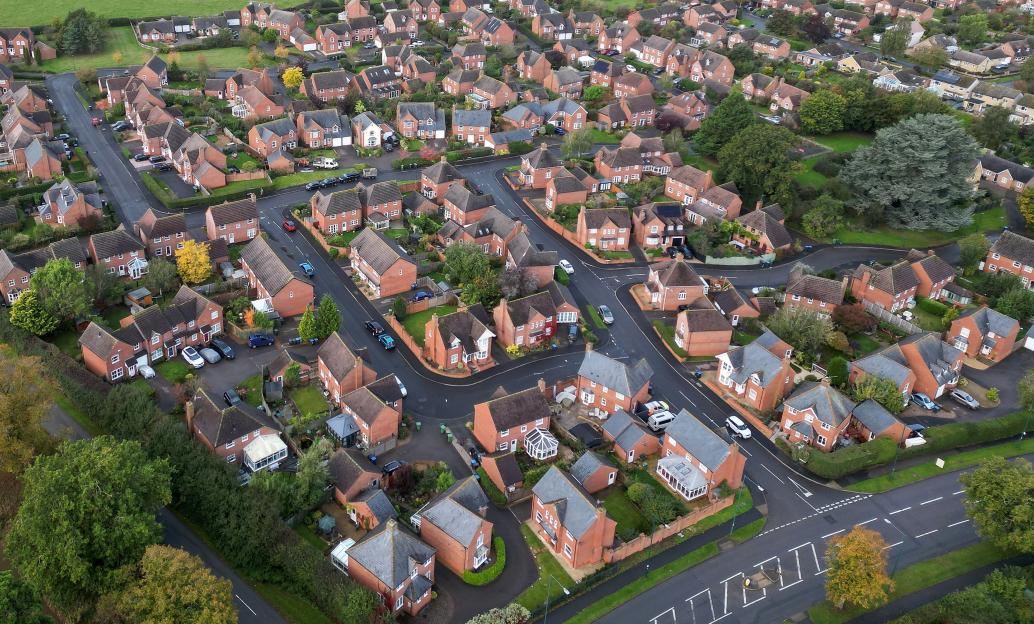 Aerial view of a residential neighborhood with many houses and winding roads.