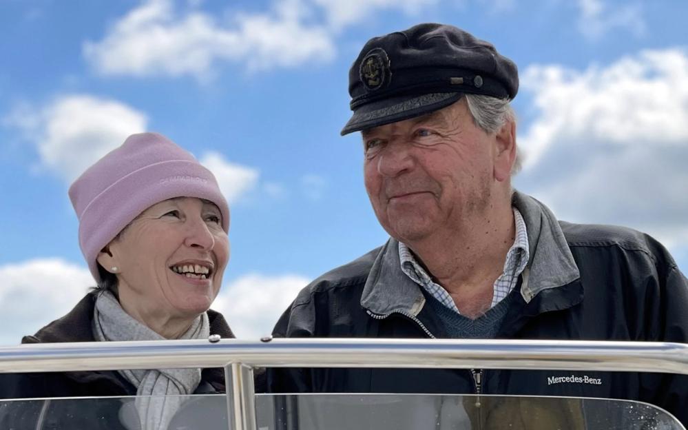 Heather and Michael Newton smiling on a boat.