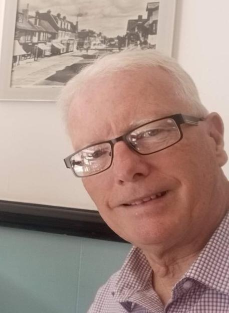 Andrew Avery, a man with white hair and glasses, smiling.