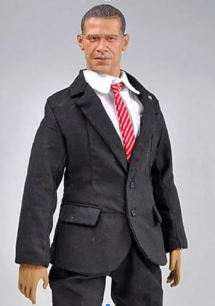 An action figure modeled after Barack Obama, wearing a black suit, white shirt, and red and white striped tie.