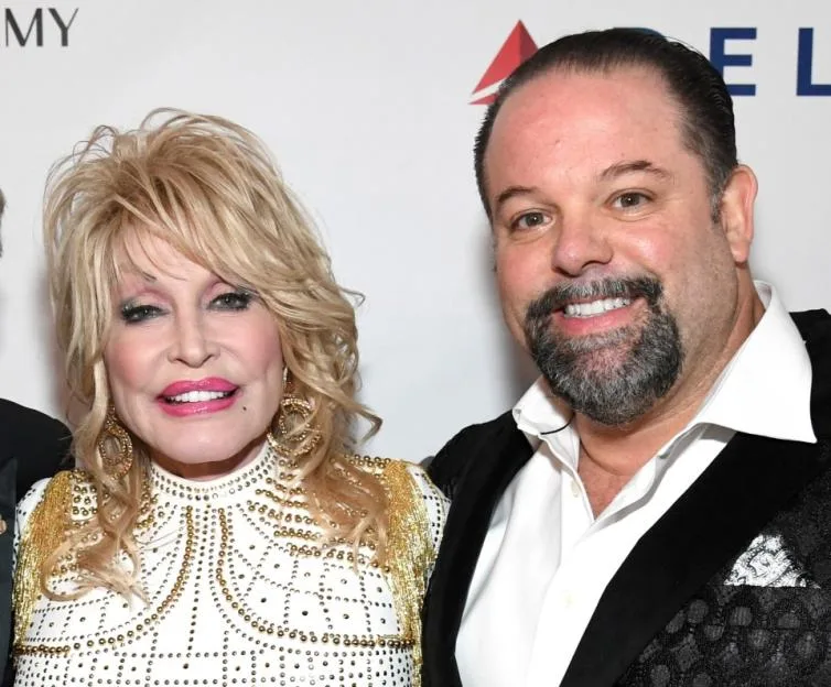 Dolly Parton poses between Neil Portnow and Danny Nozell at the MusiCares Person of the Year event.