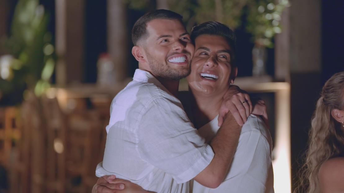 Joe and Junaid from "The Only Way Is Essex" embracing and smiling.
