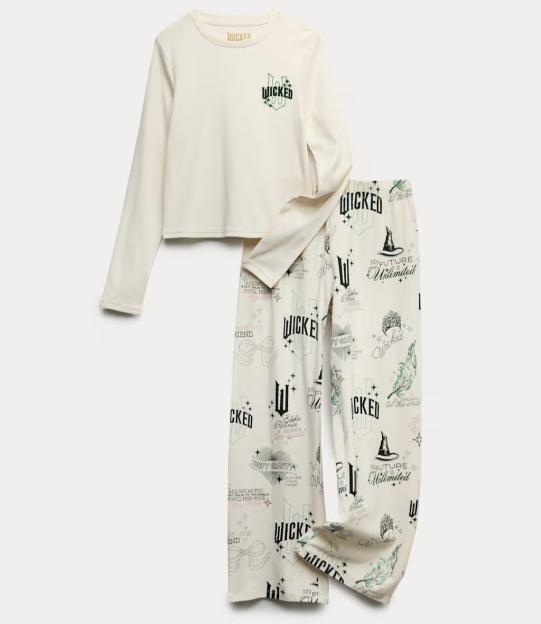 White long-sleeved pajamas with "Wicked" branding on the top and various "Wicked" themed motifs and phrases on the pants.