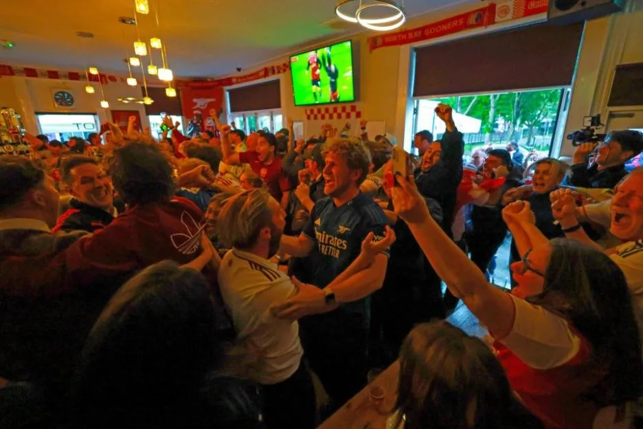 Arsenal fans celebrating at the Tollington Arms pub.