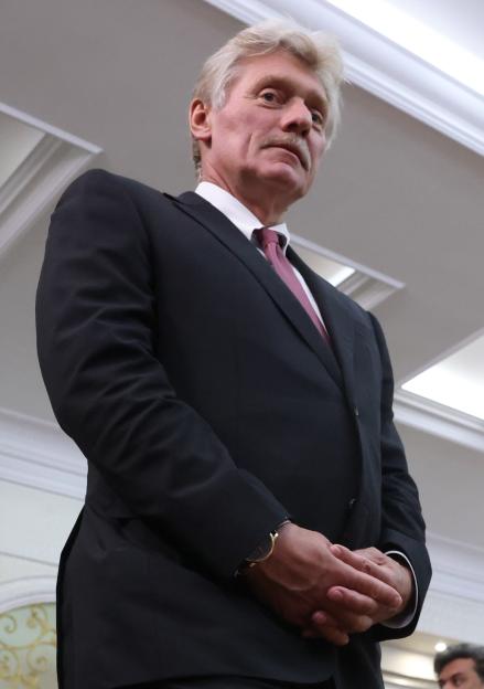 Dmitry Peskov, Russian Presidential Press Secretary, smiling prior to a bilateral meeting.