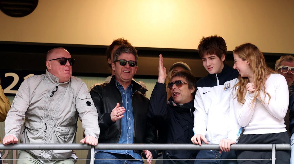 Noel and Liam Gallagher of Oasis celebrating in a corporate box at the Emirates FA Cup Final match.