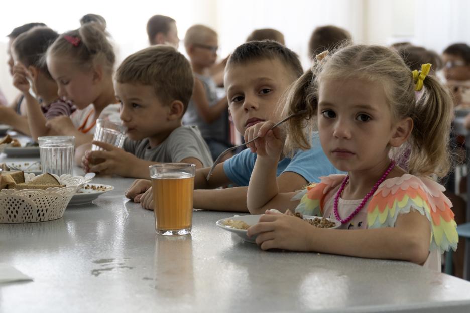 Children from an orphanage in the Donetsk region, eat a meal at a camp in Zolotaya Kosa, the settlement on the Sea of Azov, Rostov region, southwestern Russia.