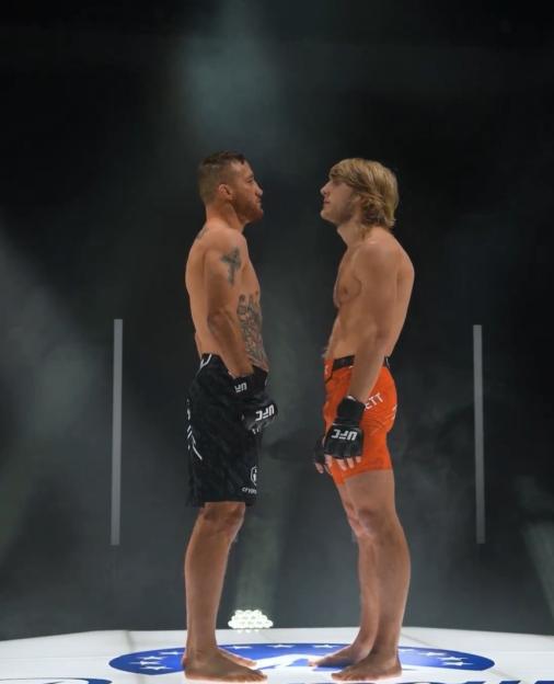 Two male fighters face each other for a stare-down.
