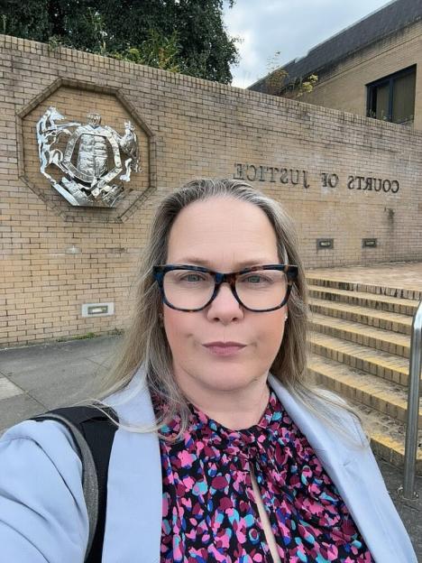 Alison McRobbie stands in front of a brick building with "COURTS OF JUSTICE" written on it.