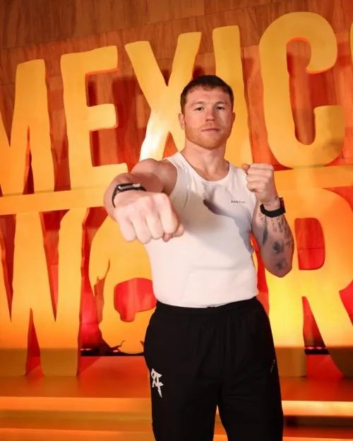 Canelo Alvarez posing with a raised fist at the Grand Arrival event.